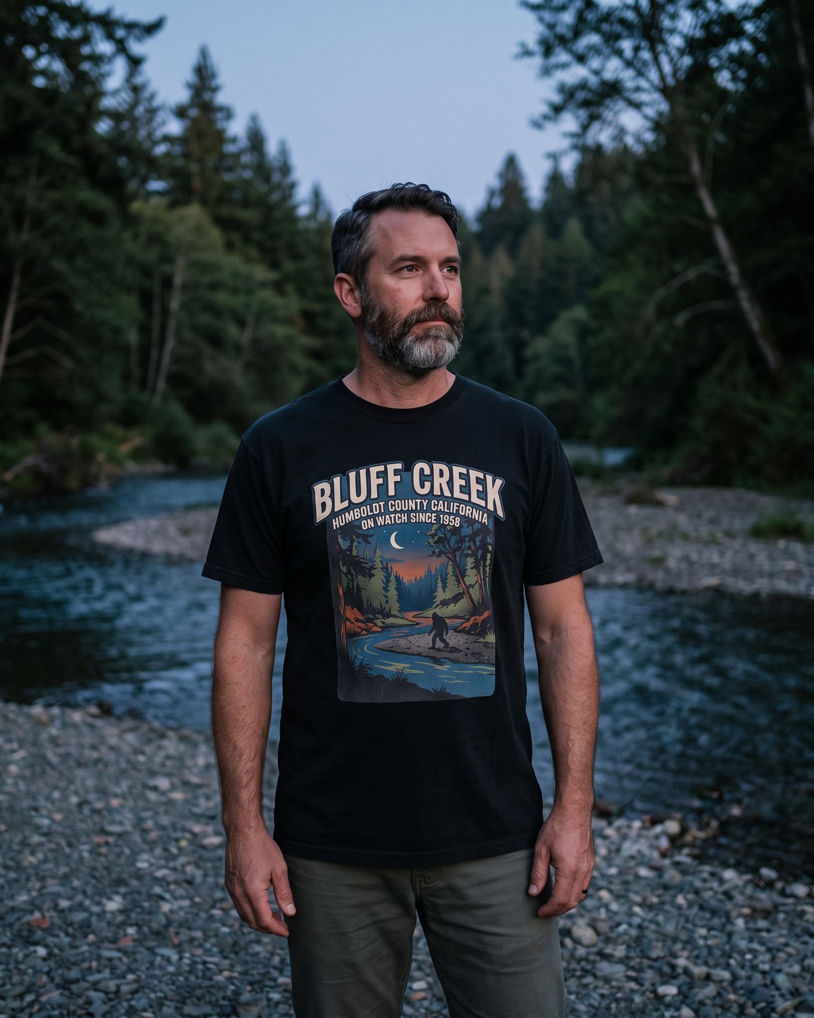 A person wearing the Bluff Creek On Watch tee in black on location near Bluff Creek, California