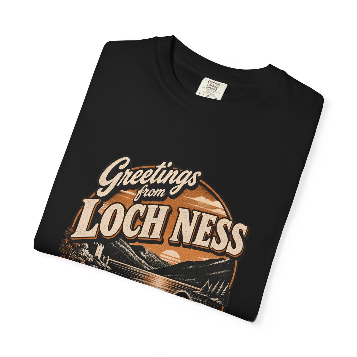 Close-up of the Greetings from Loch Ness print on a folded black tee