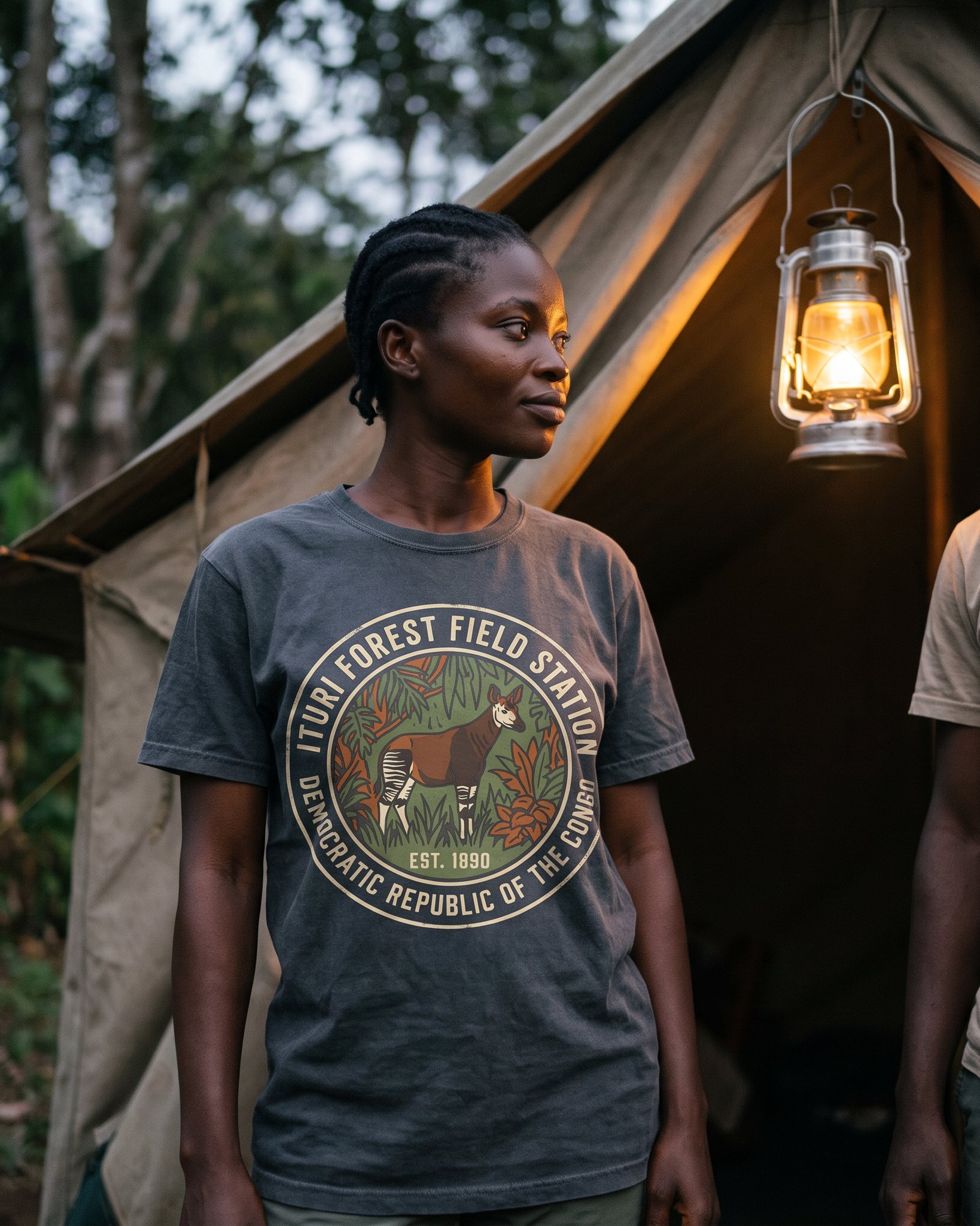 The same person wearing the Ituri Forest Field Station tee in pepper