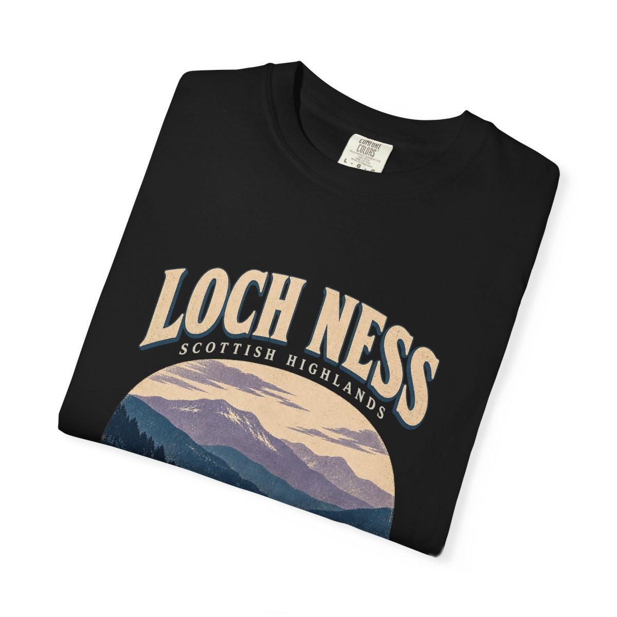 Close-up of the Loch Ness On Watch print on a folded black tee