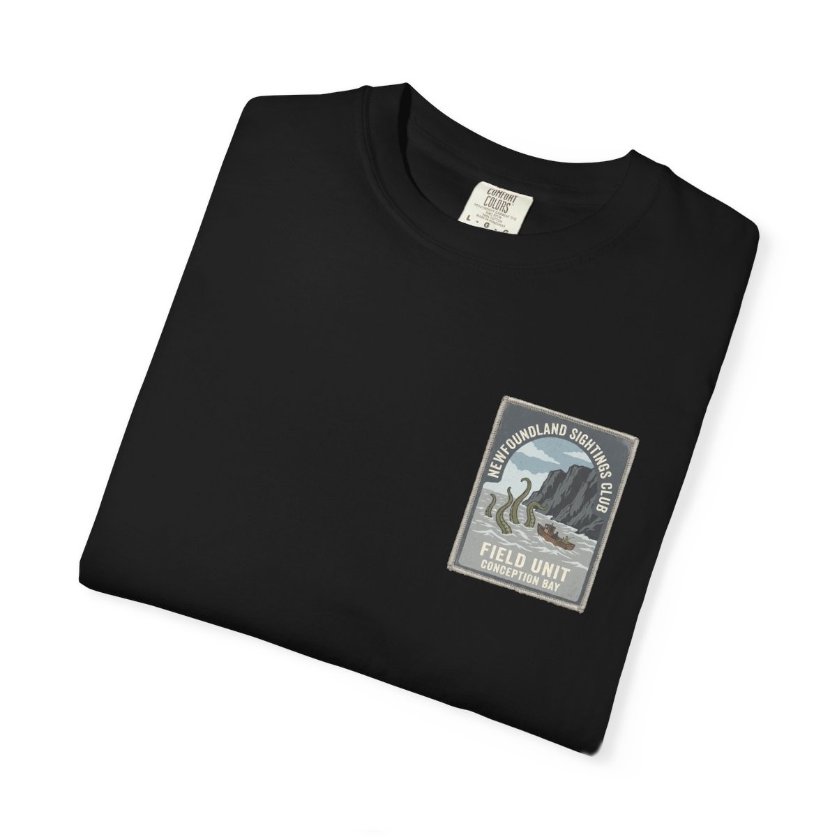 Close-up of the Newfoundland Sightings Club print on a folded black tee