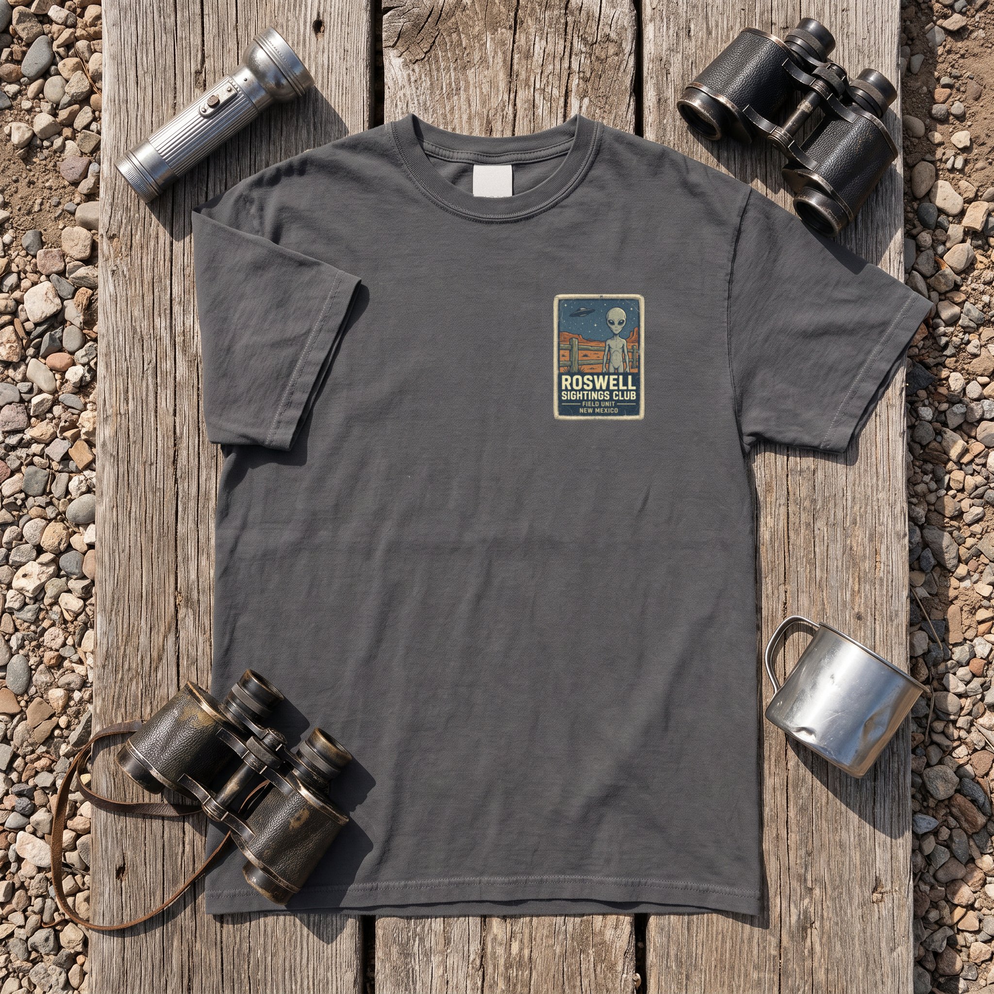 The Roswell Sightings Club tee in graphite laid flat with field kit from the Grey Alien file