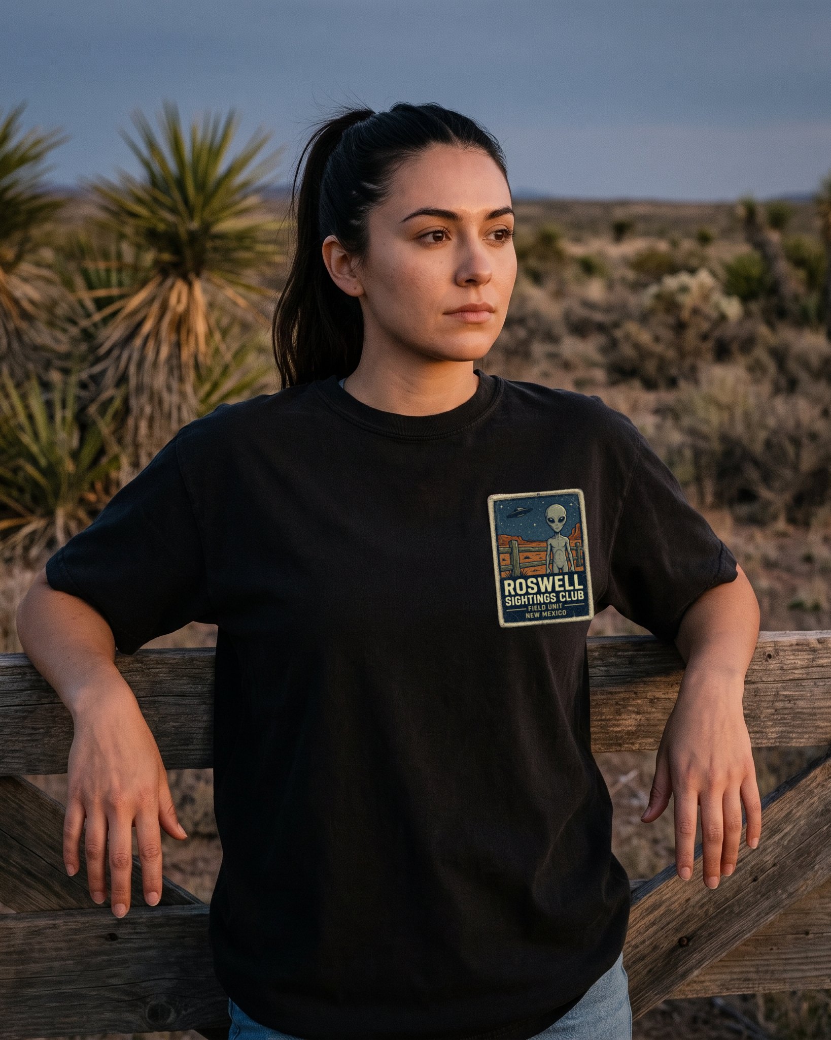 A person wearing the Roswell Sightings Club tee in black on location near Roswell, New Mexico