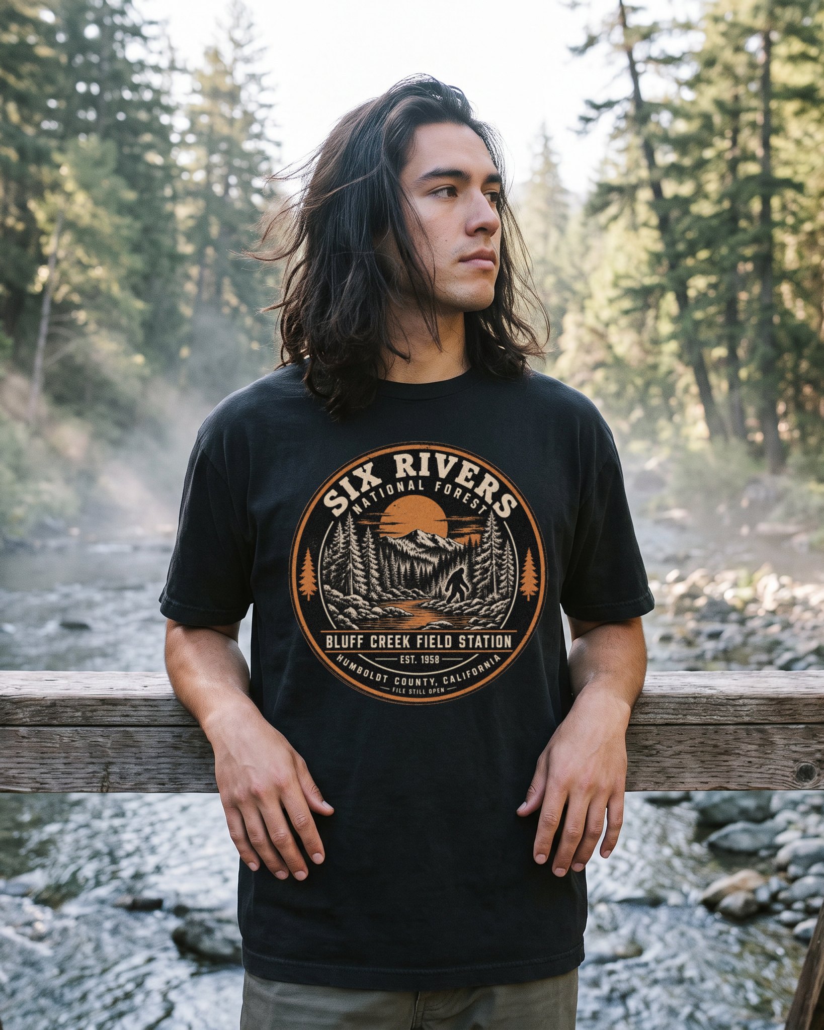 A person wearing the Six Rivers Field Station tee in black on location near Bluff Creek, California