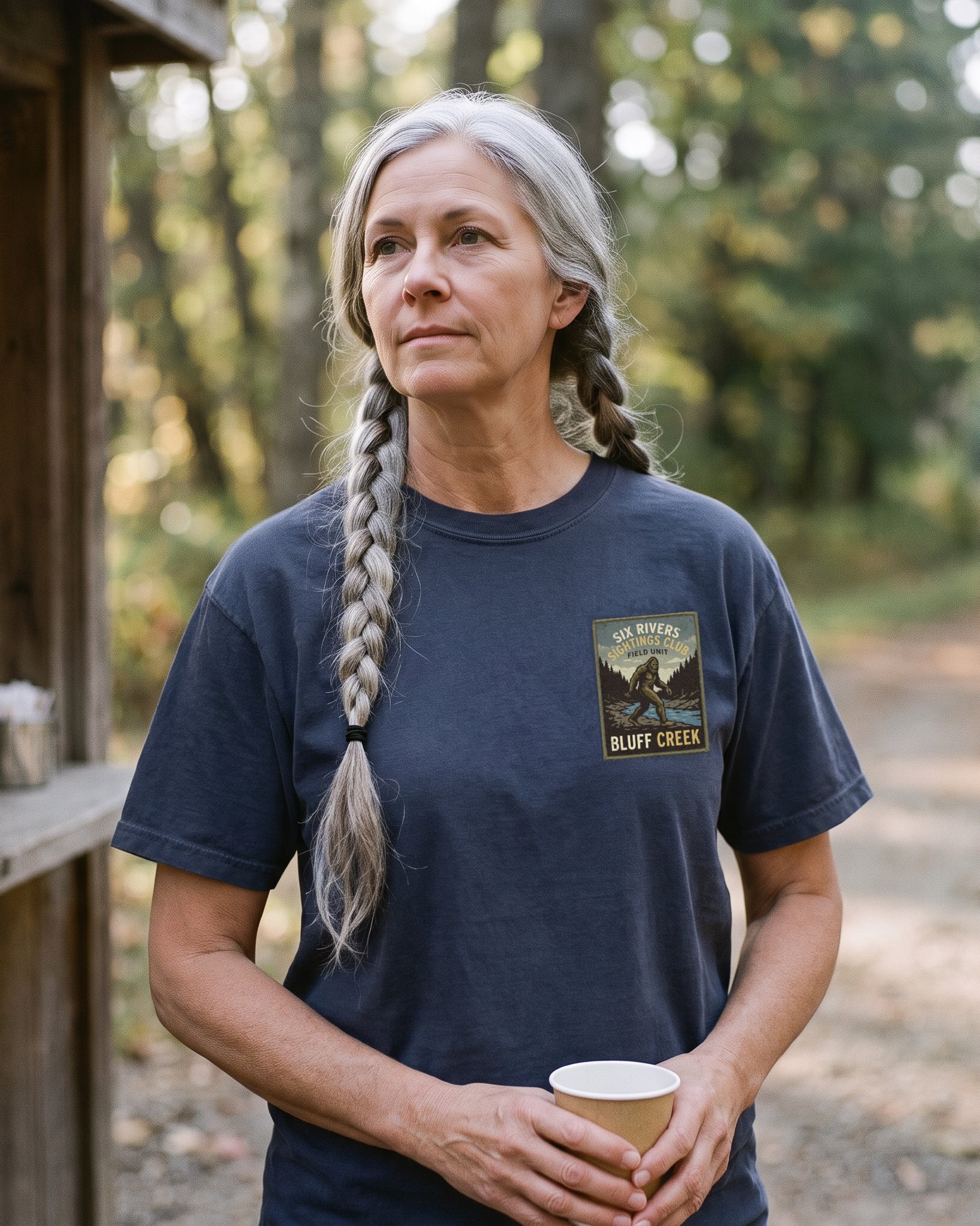 The same person wearing the Six Rivers Sightings Club tee in navy