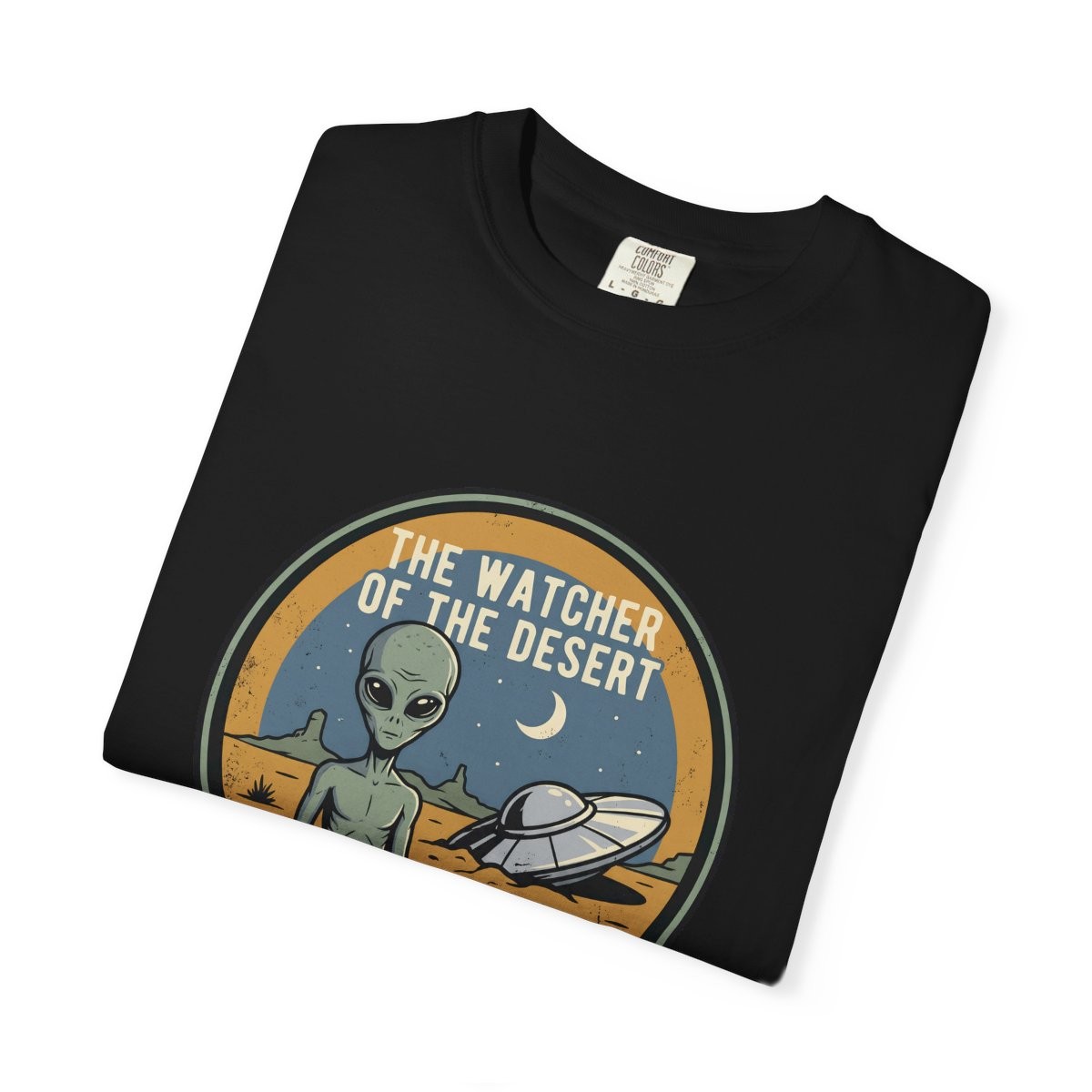 Close-up of the Watcher of the Desert print on a folded black tee