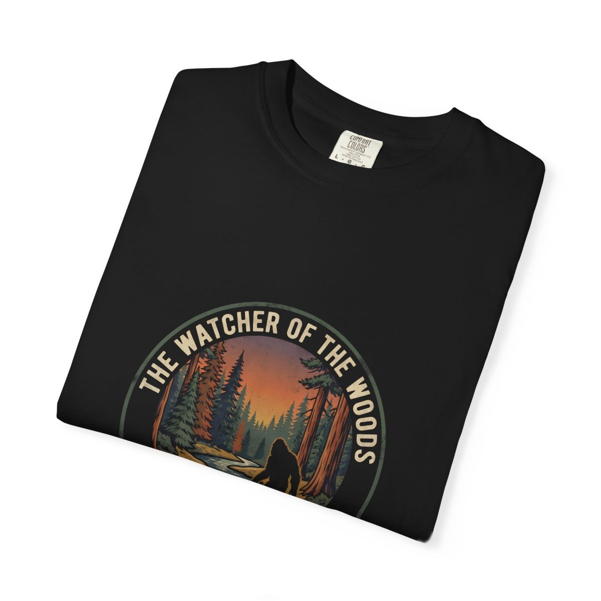 Close-up of the Watcher of the Woods print on a folded black tee